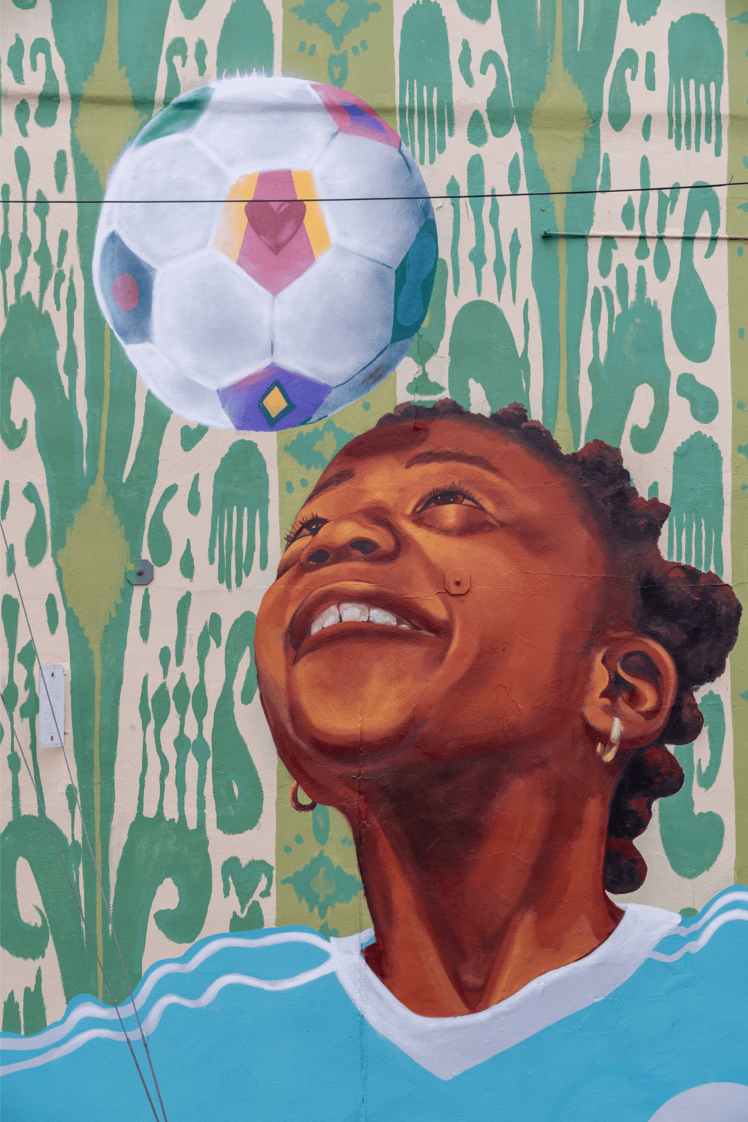 Close up of mural by Rowan Bathurst for PAAM grantee Soccer Without Borders in Baltimore City.